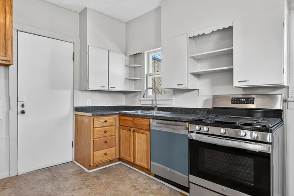 a kitchen with stainless steel appliances granite countertop a stove and a refrigerator
