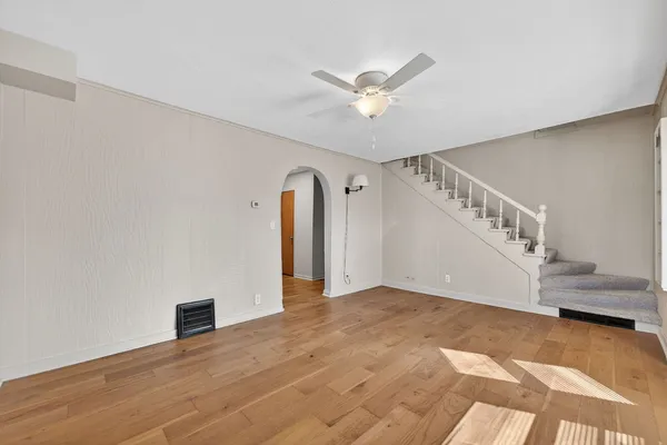 a view of an empty room with closet and a window