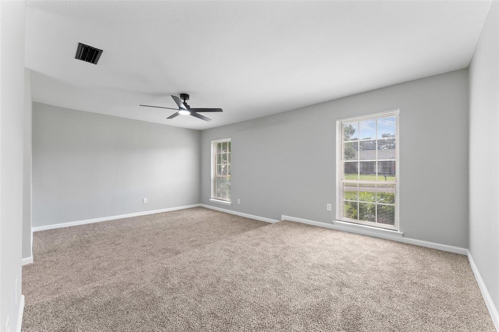 1137 Via Balboa Mesquite, TX 75150 - Photo 6 of 15 Empty room featuring light colored carpet, healthy amount of natural light, and ceiling fan