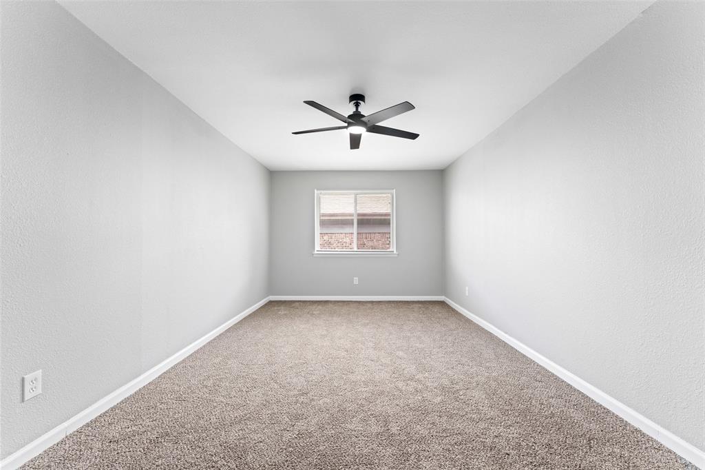 1137 Via Balboa Mesquite, TX 75150 - Photo 8 of 15 Carpeted empty room with a textured wall and ceiling fan
