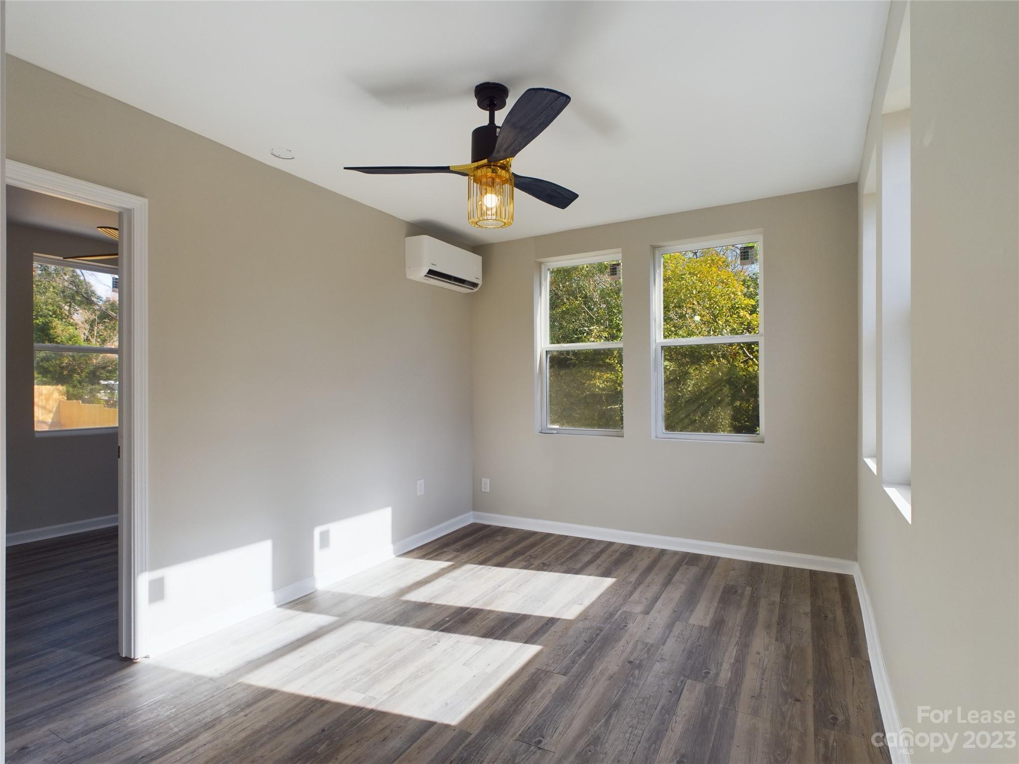503 5th Street Southwest, Unit 2 Hickory, NC 28602 - Photo 3 of 11 a view of an empty room with wooden floor and a window