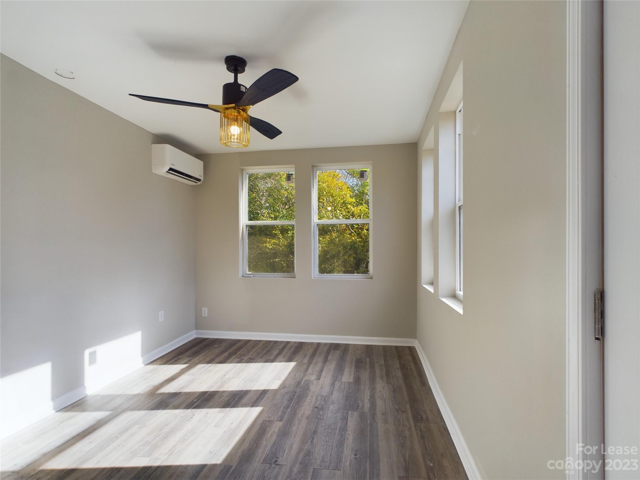 503 5th Street Southwest, Unit 2 Hickory, NC 28602 - Photo 4 of 11 a view of empty room with wooden floor and fan
