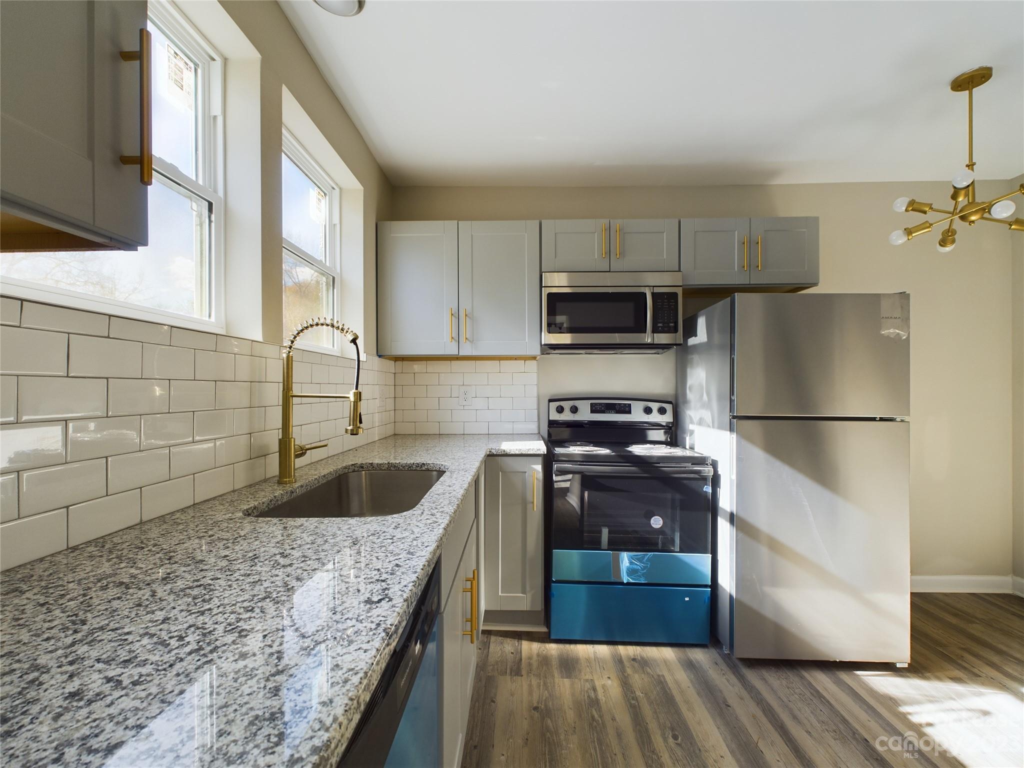 503 5th Street Southwest, Unit 2 Hickory, NC 28602 - Photo 5 of 11 a kitchen with a refrigerator sink and stove