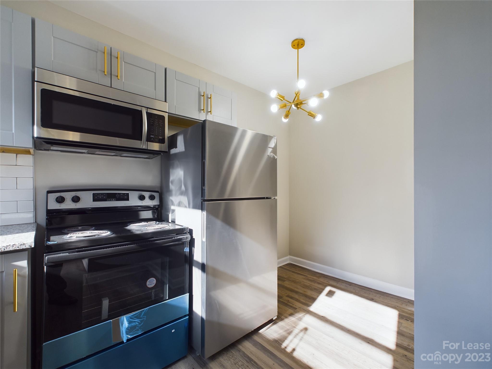 503 5th Street Southwest, Unit 2 Hickory, NC 28602 - Photo 6 of 11 a kitchen with stainless steel appliances granite countertop a refrigerator stove and microwave