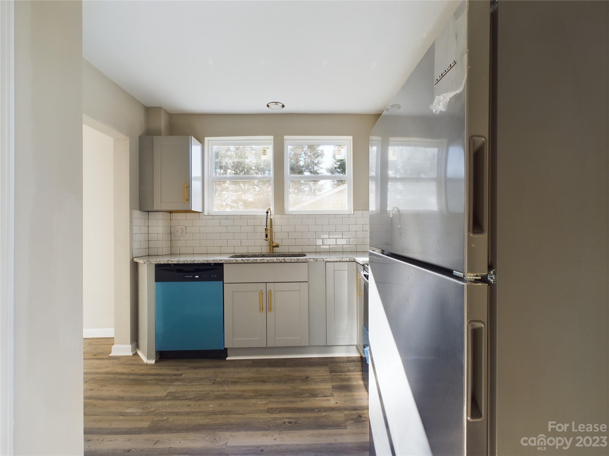 503 5th Street Southwest, Unit 2 Hickory, NC 28602 - Photo 7 of 11 a kitchen with granite countertop a refrigerator and a sink