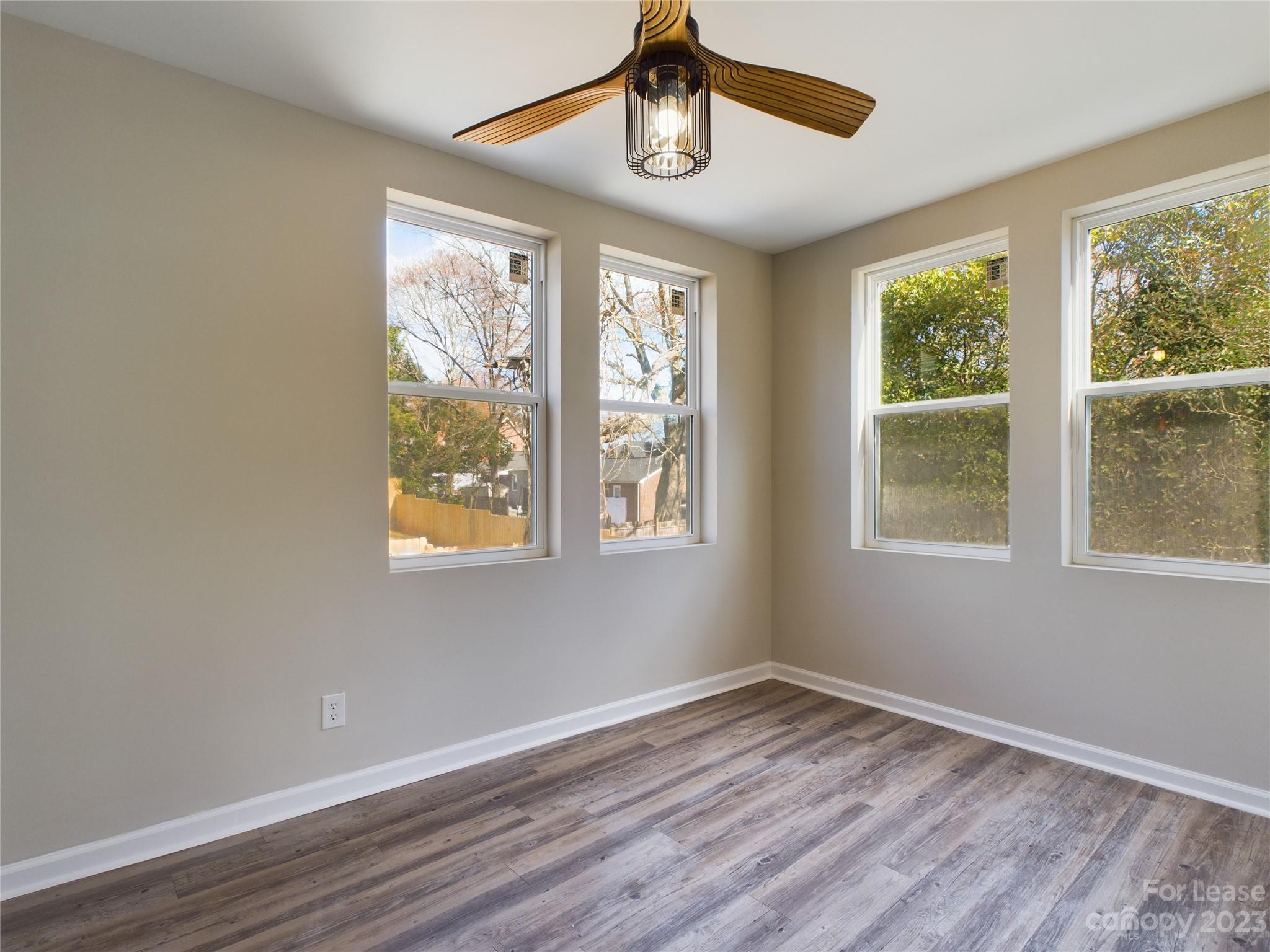 503 5th Street Southwest, Unit 2 Hickory, NC 28602 - Photo 8 of 11 a view of an empty room with wooden floor and windows