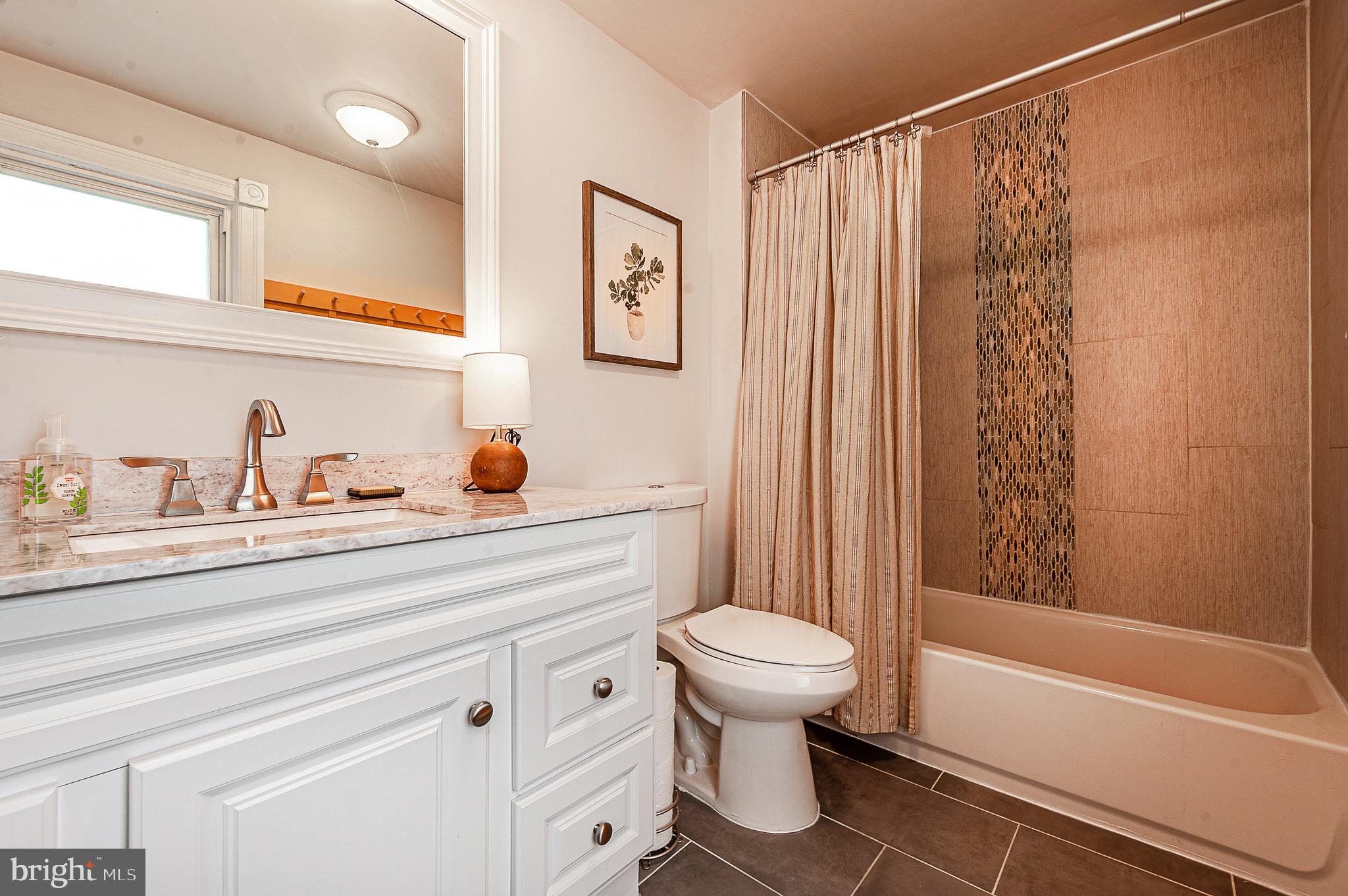 584 Clems Run Mullica Hill, NJ 08062 - Photo 16 of 23 a bathroom with a sink a toilet and a bathtub