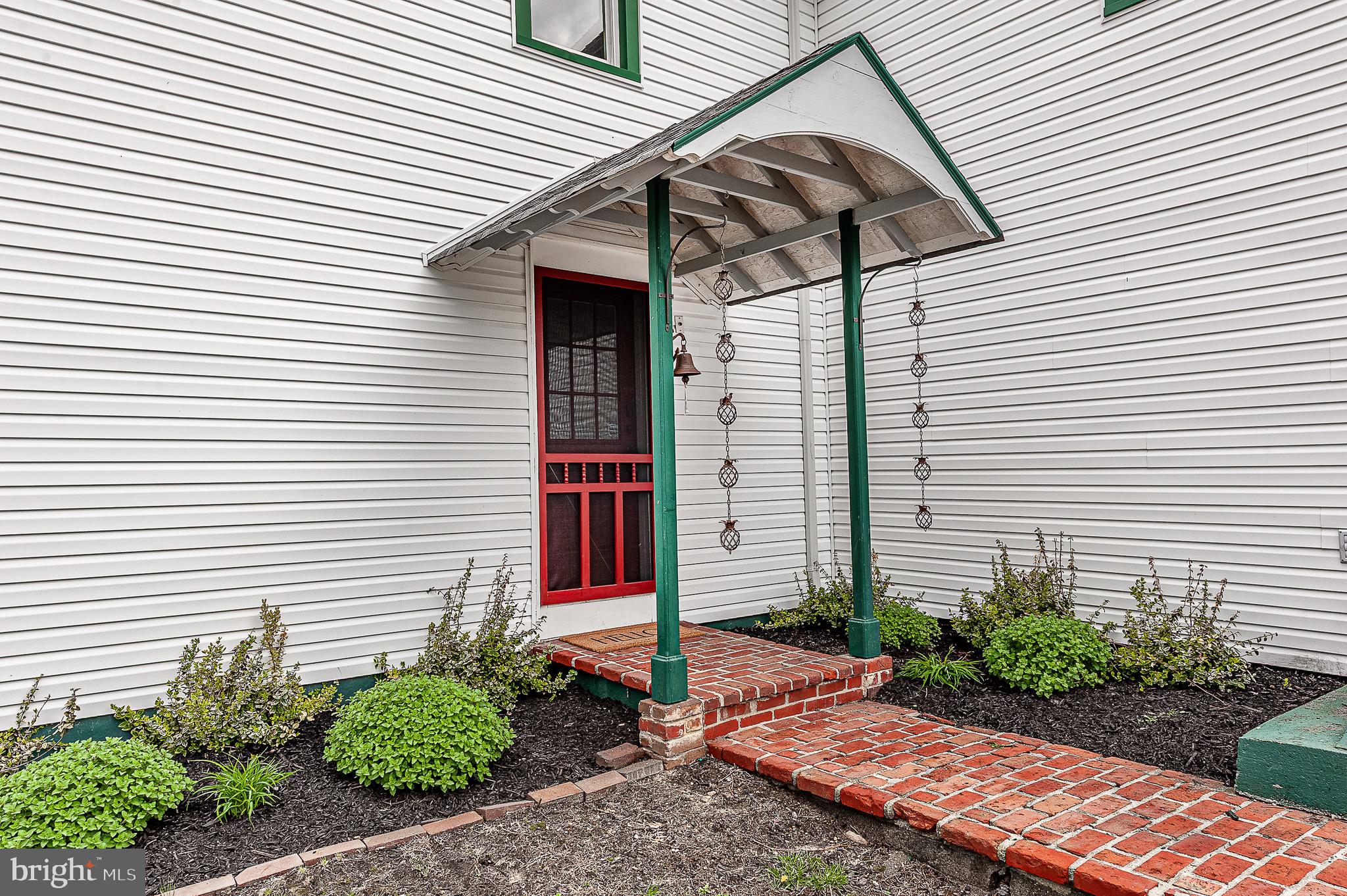 584 Clems Run Mullica Hill, NJ 08062 - Photo 5 of 23 a view of a white house with a small window and potted plants
