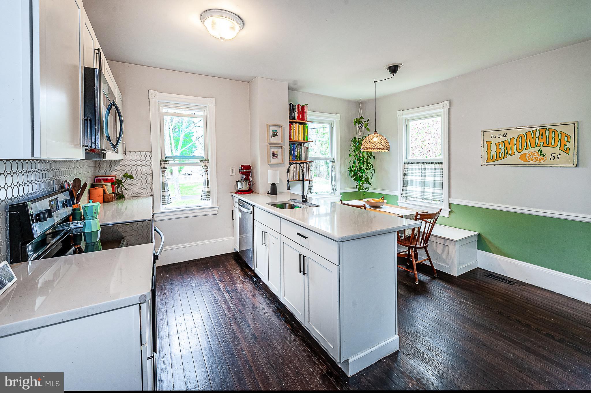 584 Clems Run Mullica Hill, NJ 08062 - Photo 8 of 23 a kitchen with a sink cabinets and wooden floor