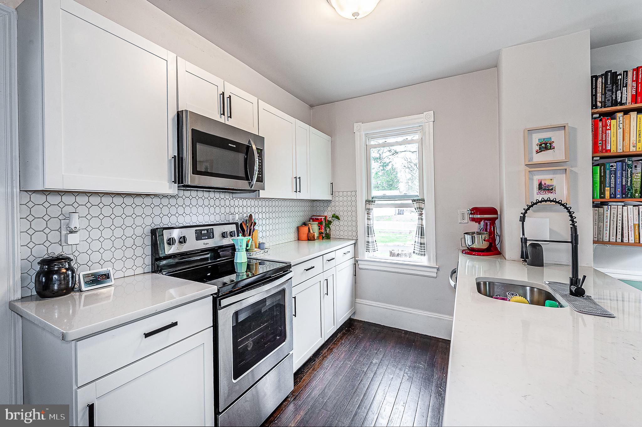 584 Clems Run Mullica Hill, NJ 08062 - Photo 9 of 23 a kitchen with white cabinets and white appliances