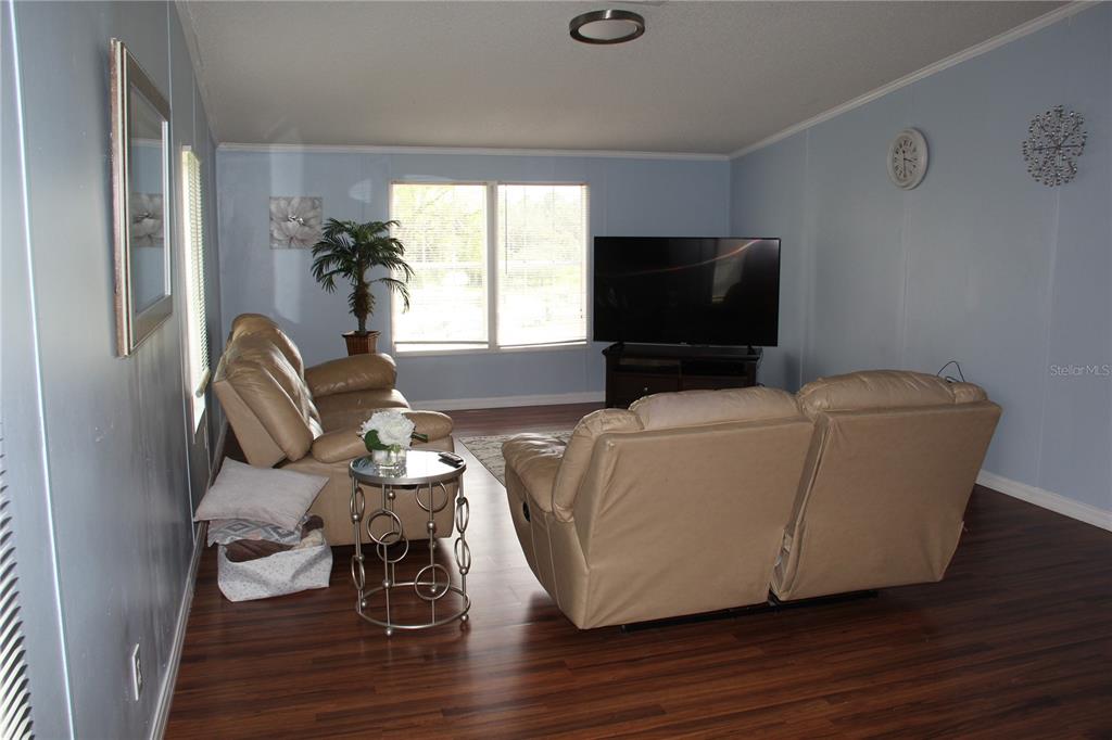 13127 Star Road Brooksville, FL 34613 - Photo 17 of 54 a living room with furniture and a flat screen tv