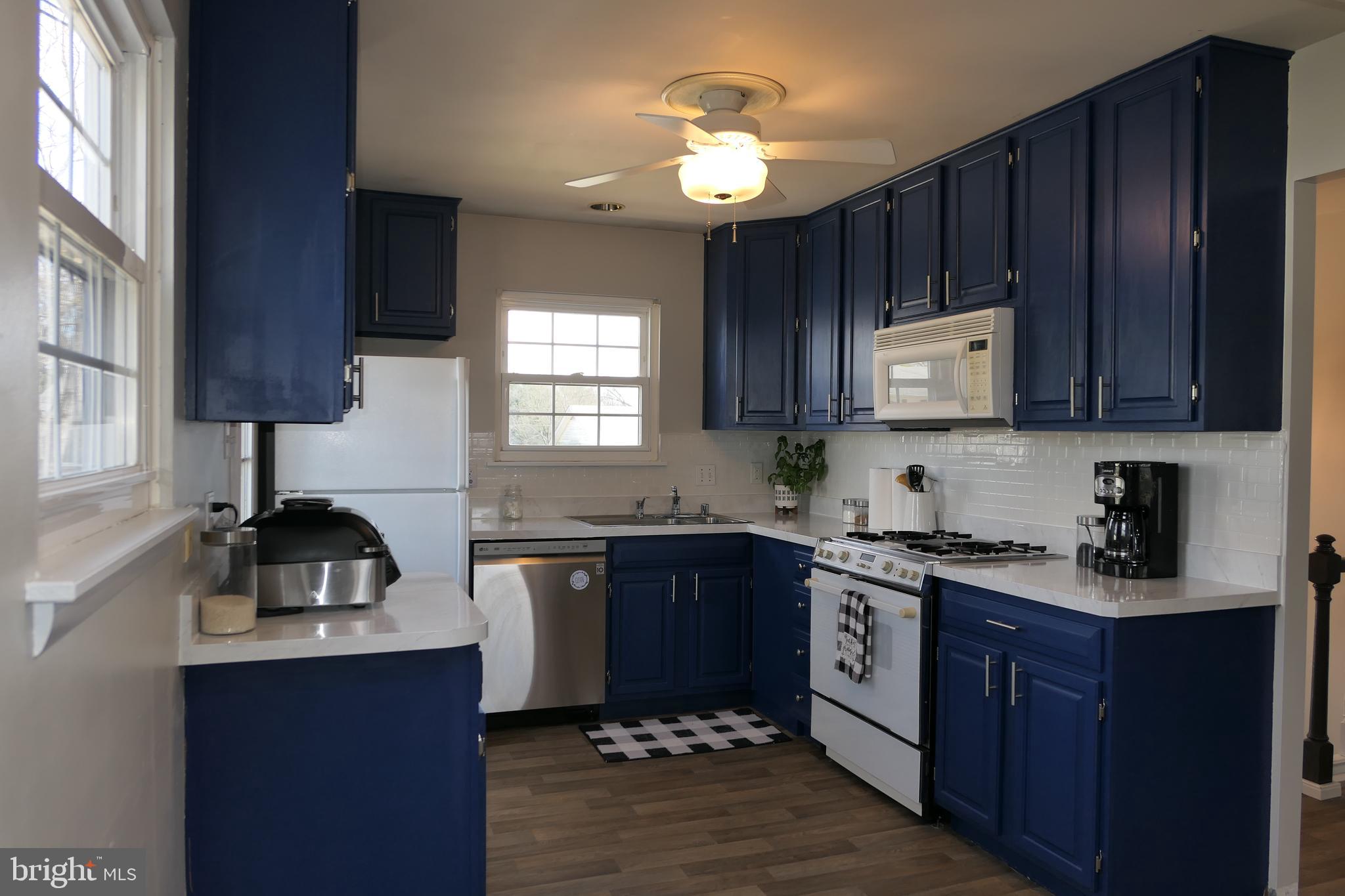206 Stanlake Road Owings Mills, MD 21117 - Photo 14 of 31 a kitchen with a sink a stove a microwave and cabinets
