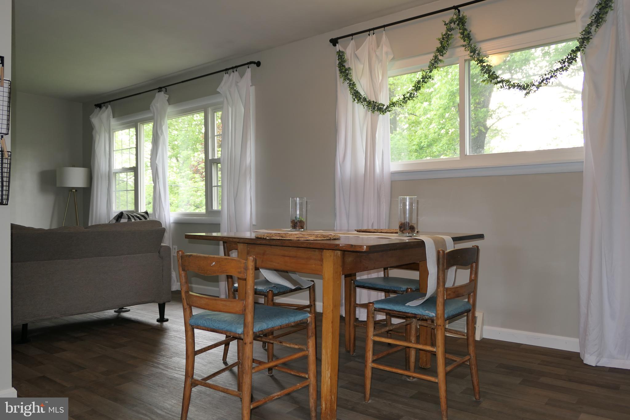 206 Stanlake Road Owings Mills, MD 21117 - Photo 3 of 31 a view of a dining room with furniture and wooden floor