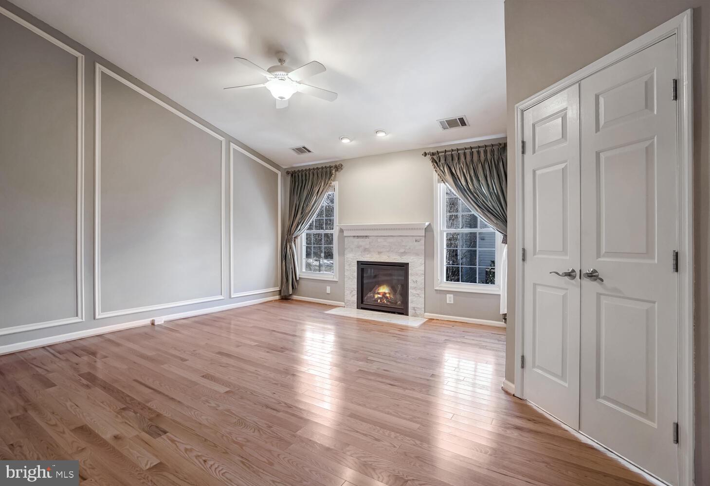 1794 Dawson Street Vienna, VA 22182 - Photo 14 of 30 an empty room with wooden floor fireplace and windows