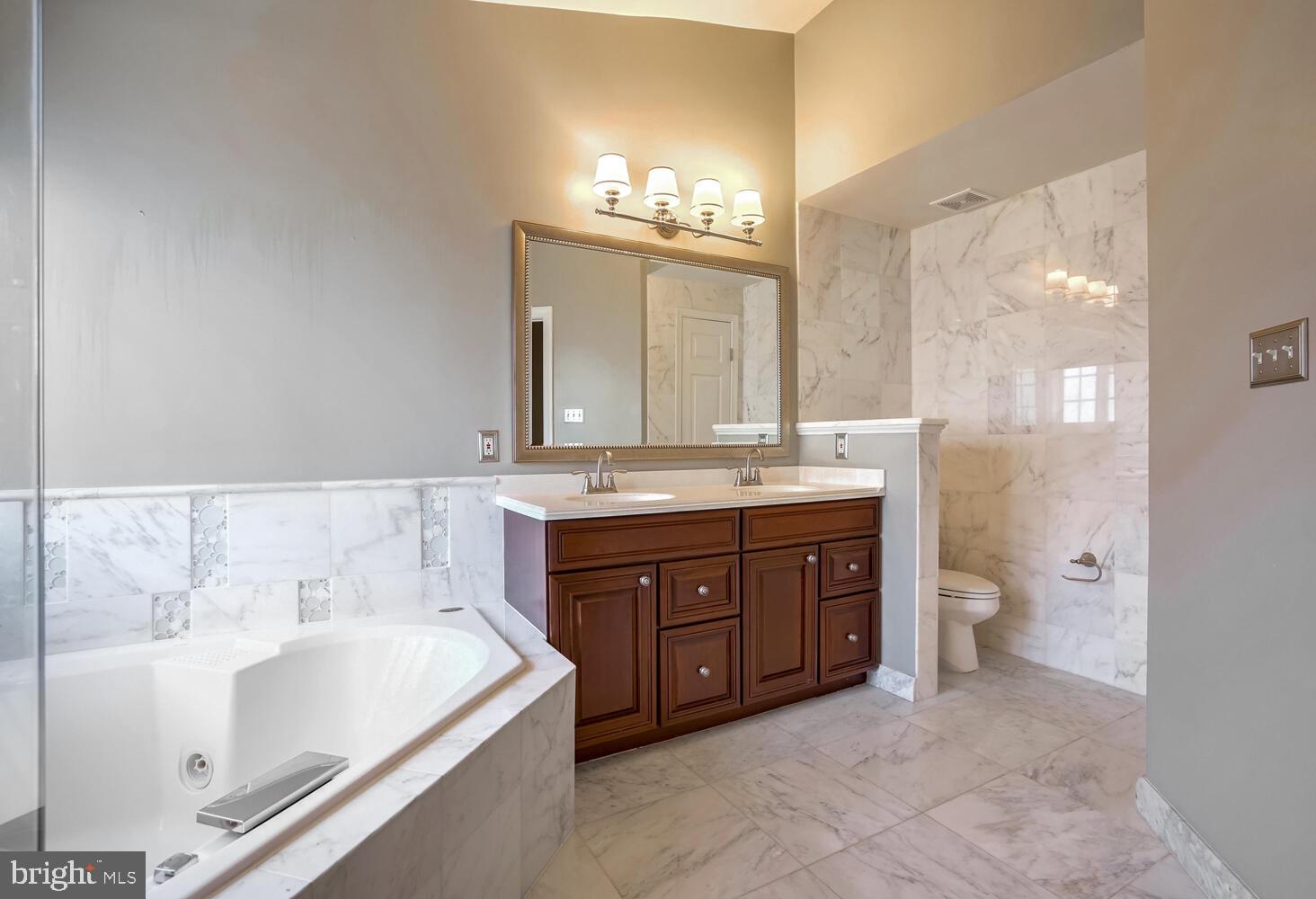 1794 Dawson Street Vienna, VA 22182 - Photo 16 of 30 a bathroom with a tub sink and mirror