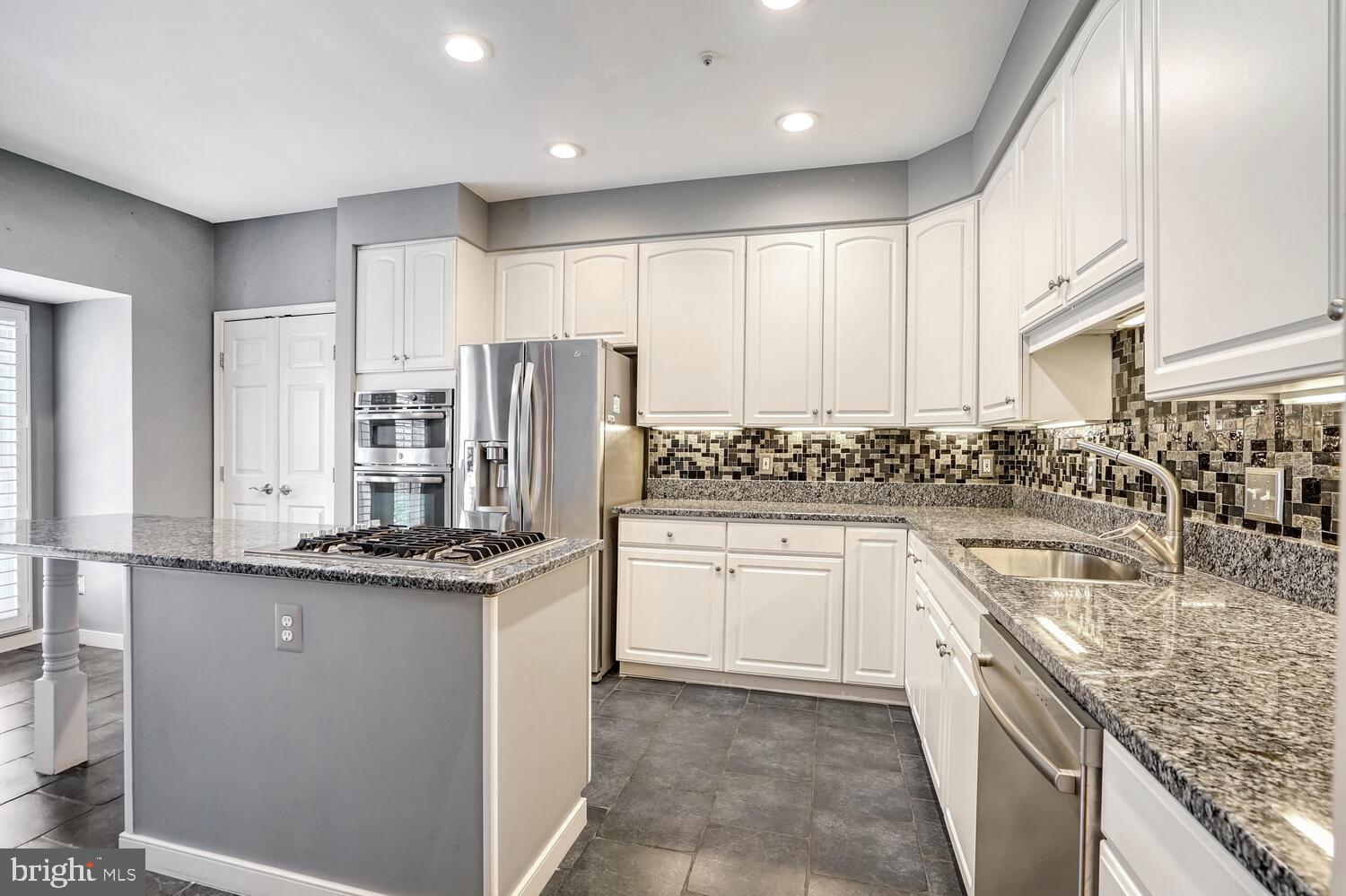 1794 Dawson Street Vienna, VA 22182 - Photo 3 of 30 a kitchen with stainless steel appliances granite countertop a sink and cabinets