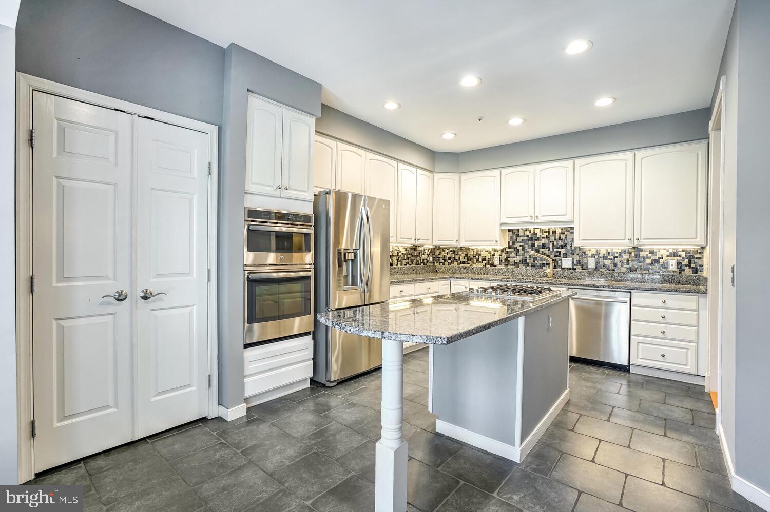 1794 Dawson Street Vienna, VA 22182 - Photo 4 of 30 a kitchen with stainless steel appliances granite countertop a refrigerator and a sink