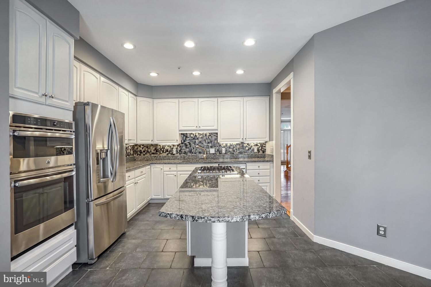 1794 Dawson Street Vienna, VA 22182 - Photo 5 of 30 a kitchen with stainless steel appliances granite countertop a stove a sink and a refrigerator