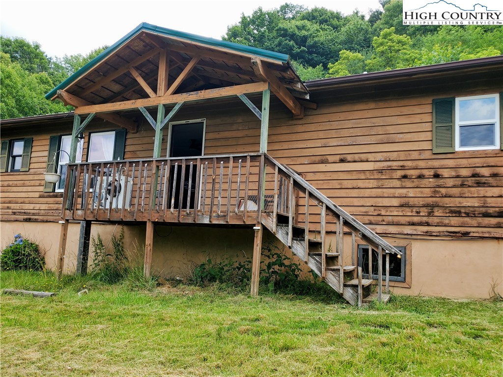 183 Clawson Road Butler, TN 37640 - Photo 1 of 13 a house with river in front of it