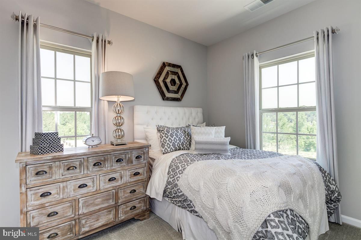 7917 Gladden Farm Way Hanover, MD 21076 - Photo 15 of 27 a bedroom with a bed and a window