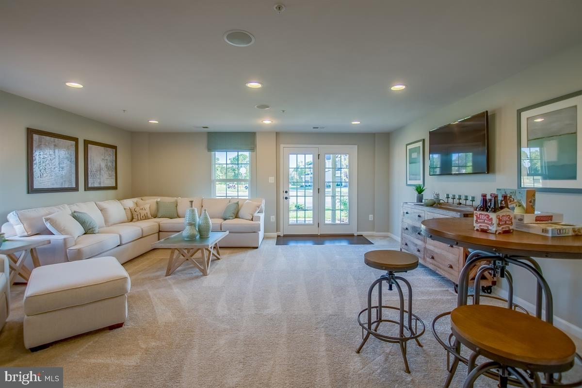 7917 Gladden Farm Way Hanover, MD 21076 - Photo 17 of 27 a living room with furniture and a flat screen tv