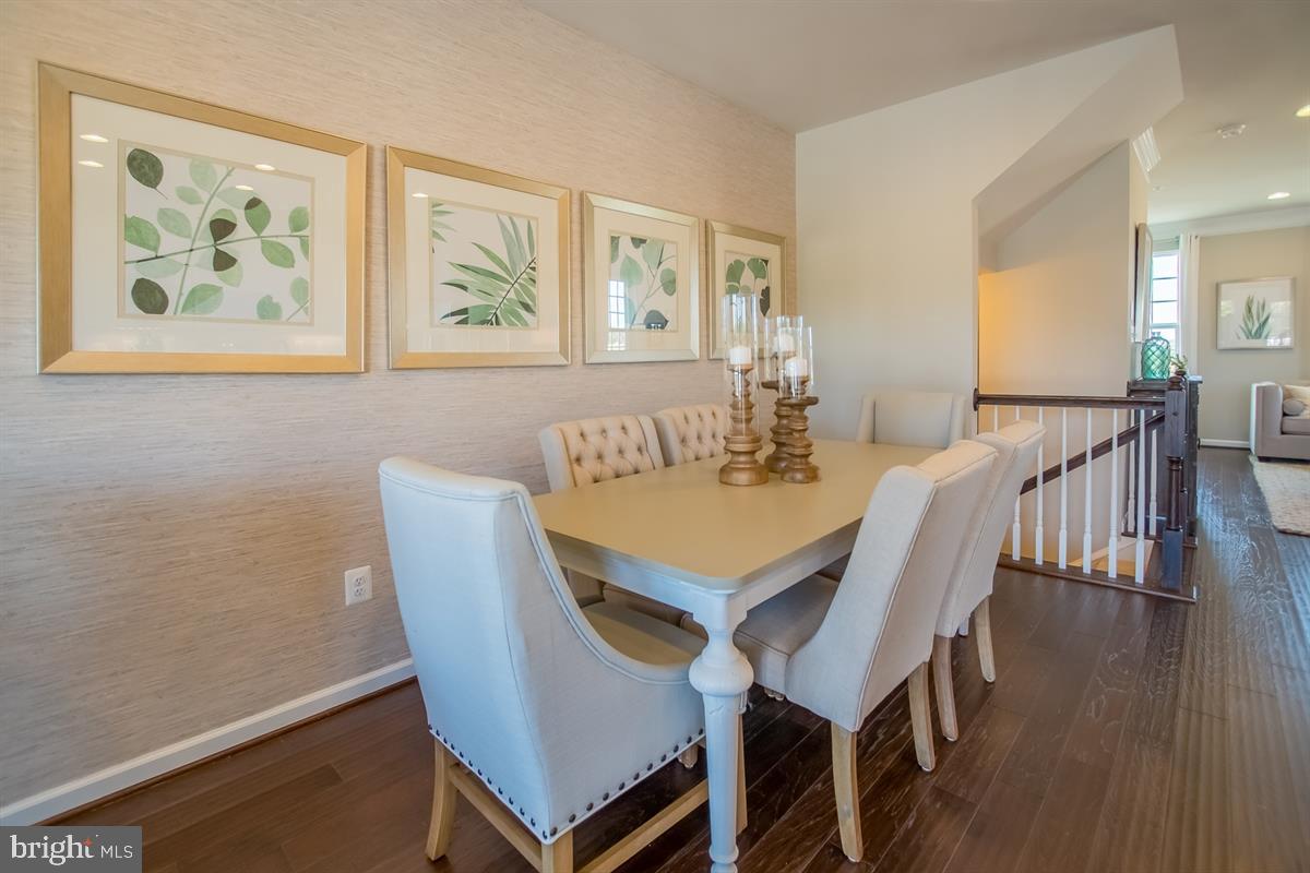7917 Gladden Farm Way Hanover, MD 21076 - Photo 6 of 27 a view of a dining room with furniture wooden floor and a window