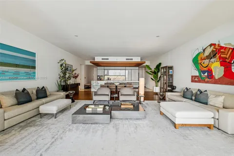 a living room with furniture and flowers