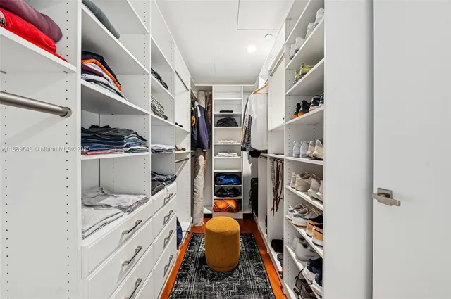 a bathroom with a double vanity sink a large mirror and a bathtub