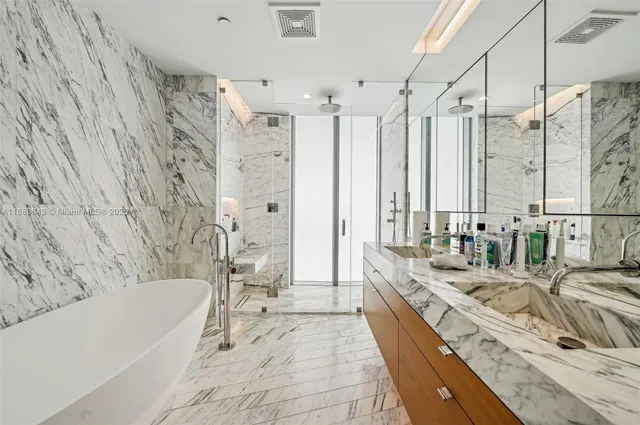 a bathroom with a bathtub and a shower