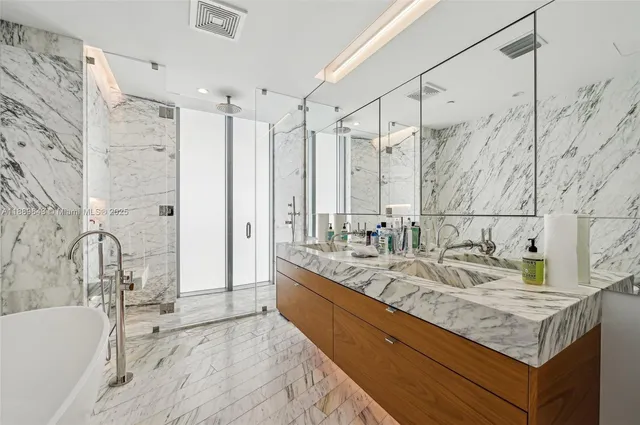 a bathroom with a bathtub and shower