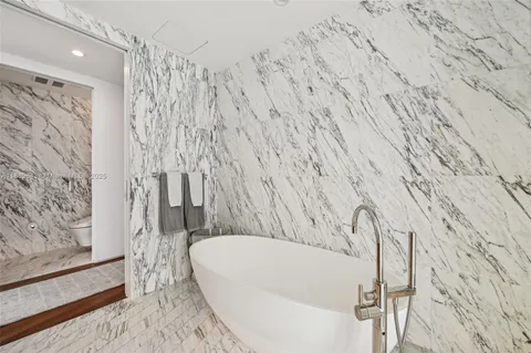 a bathroom with a double vanity sink mirror and shower