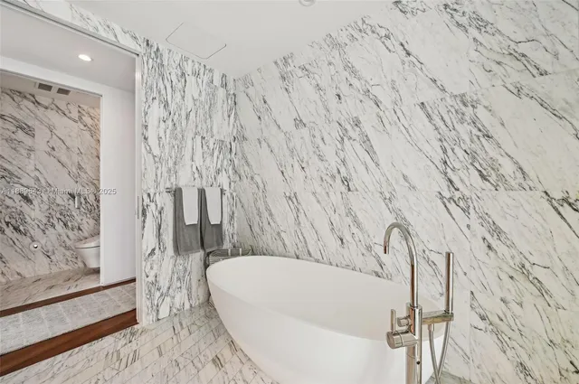 a bathroom with a double vanity sink mirror and shower