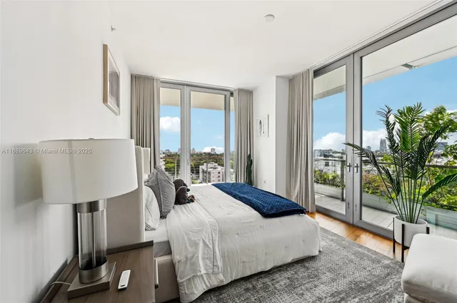 a living room with furniture floor to ceiling window and wooden floor