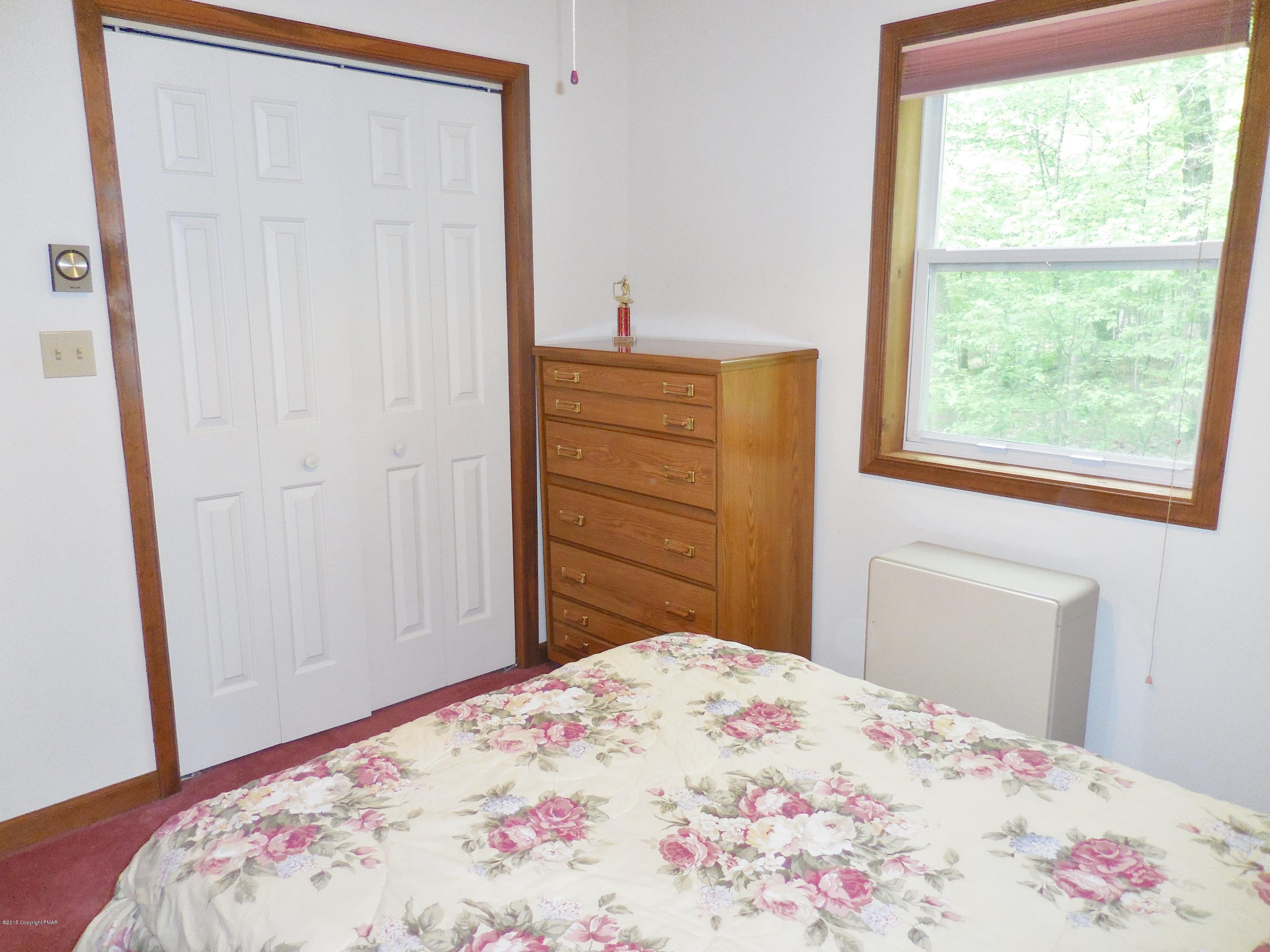 340 Timber Hill Road Henryville, PA 18332 - Photo 20 of 39 a bedroom with a bed and a dresser in it