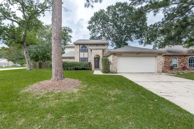 a view of a house with yard and tree s