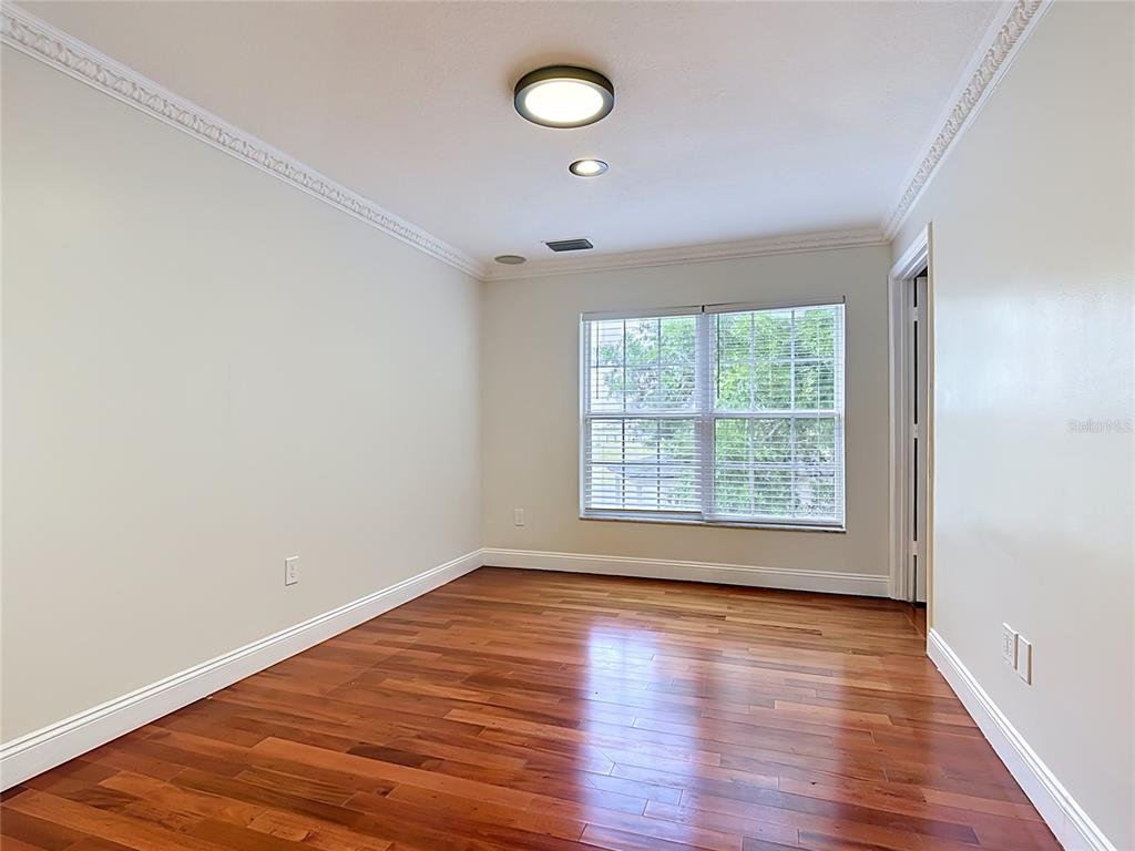 7925 Lake Mabel Loop Road Lake Wales, FL 33898 - Photo 50 of 97 an empty room with wooden floor and windows