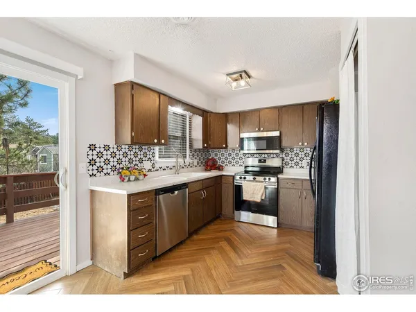 a kitchen with stainless steel appliances kitchen island granite countertop a refrigerator and a stove top oven