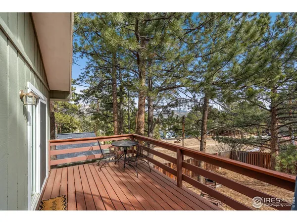 a view of balcony with wooden floor and fence