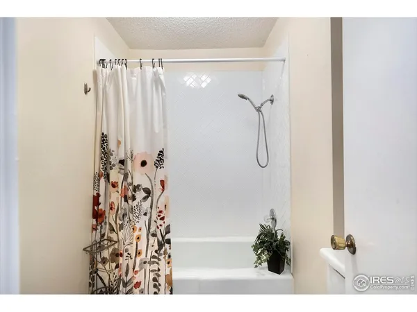 a bathroom with a shower and a bath tub