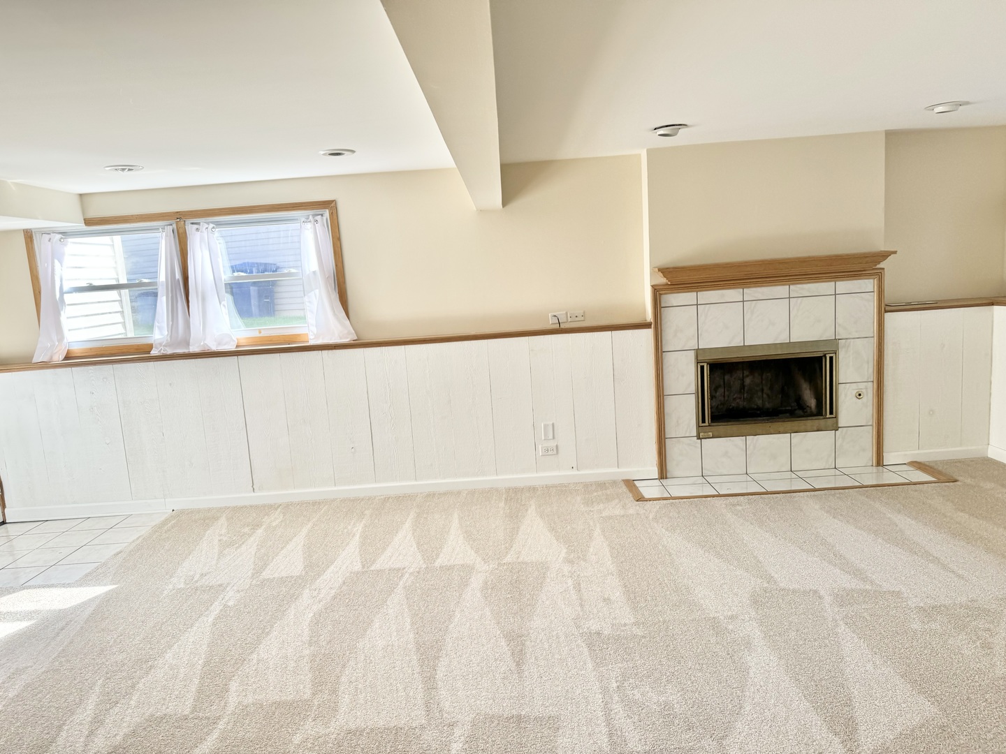 17588 West Summit Drive Grayslake, IL 60030 - Photo 13 of 19 a view of an empty room with a fireplace and a window