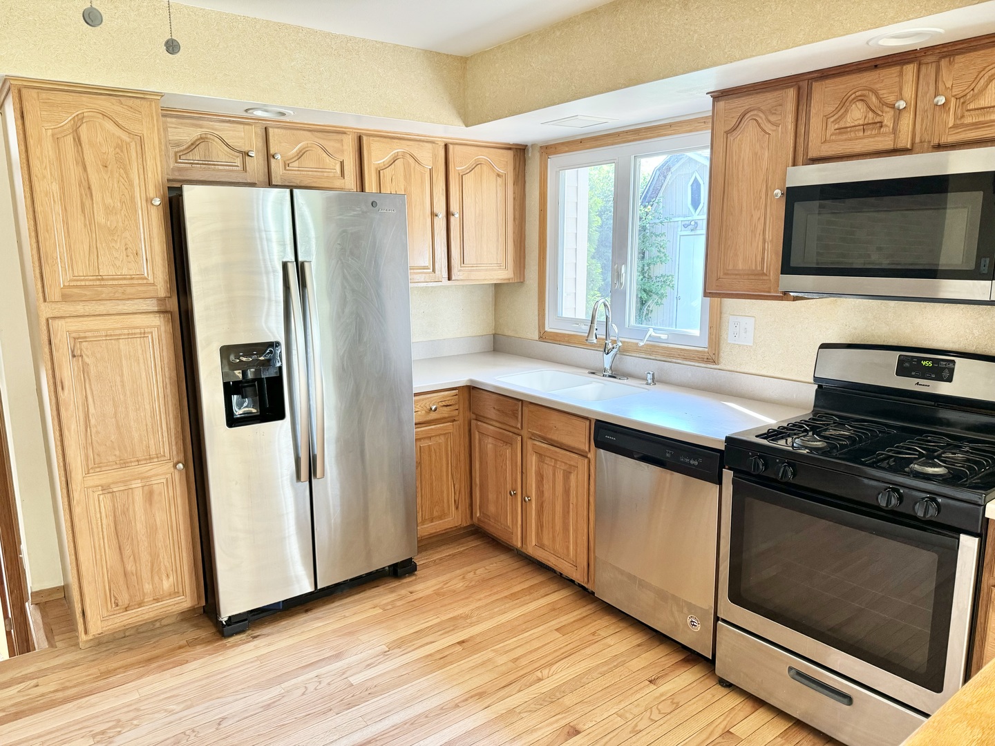 17588 West Summit Drive Grayslake, IL 60030 - Photo 3 of 19 a kitchen with stainless steel appliances a stove a microwave and a refrigerator