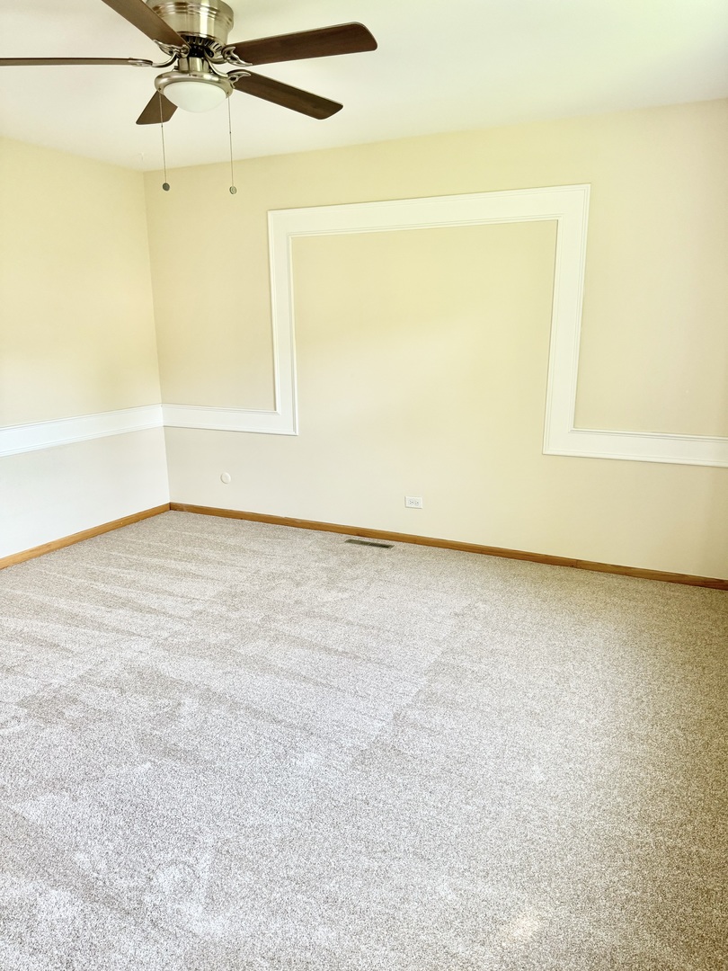 17588 West Summit Drive Grayslake, IL 60030 - Photo 6 of 19 an empty room with a window and a ceiling fan