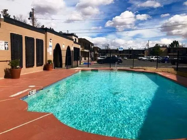 a view of a swimming pool with a yard