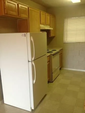 a utility room with wooden floor and cabinets