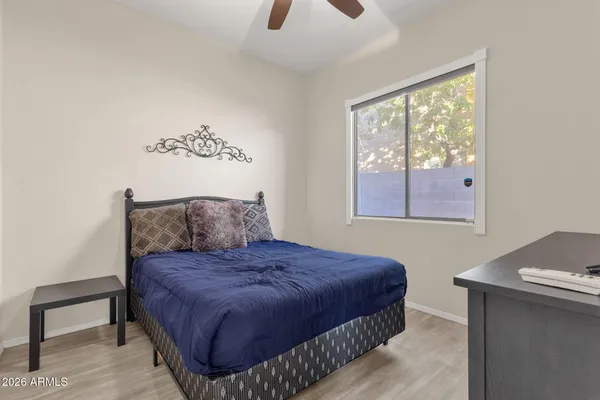 a bedroom with a bed and a window