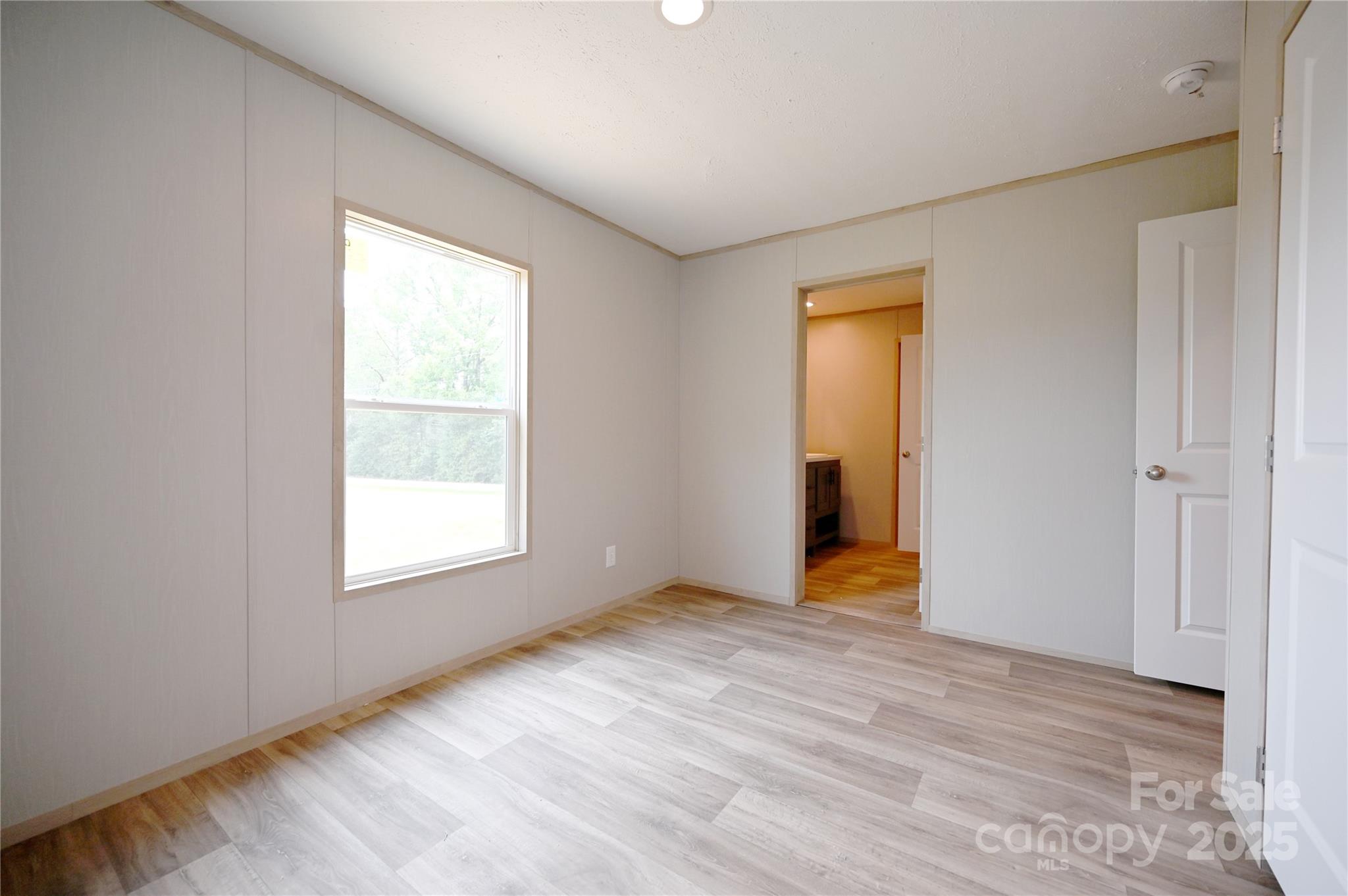 1157 Renno Road Clinton, SC 29325 - Photo 12 of 24 an empty room with a window and a bathroom