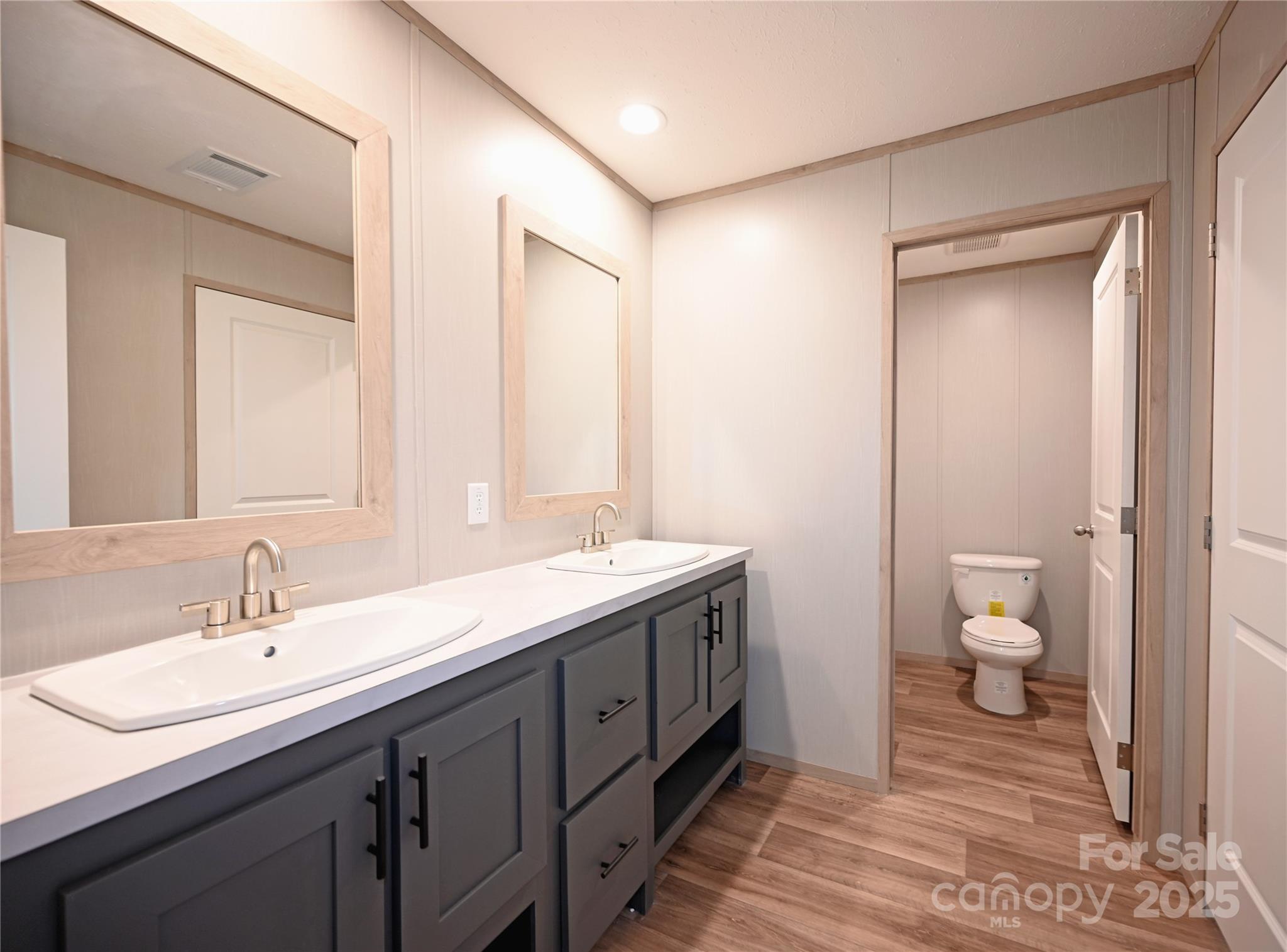 1157 Renno Road Clinton, SC 29325 - Photo 13 of 24 a bathroom with a sink a toilet and a large mirror