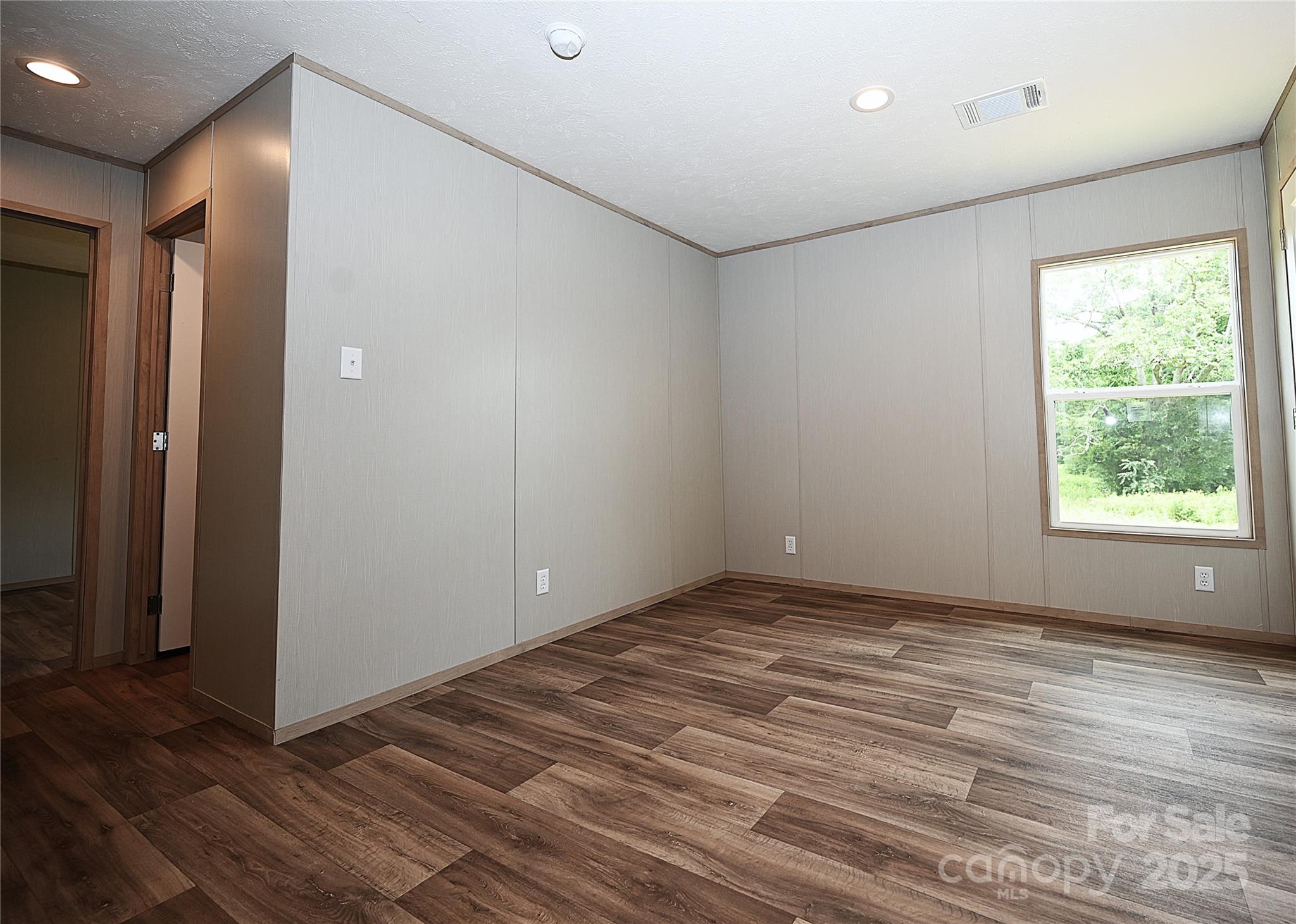 1157 Renno Road Clinton, SC 29325 - Photo 18 of 24 a view of an empty room with wooden floor and a window