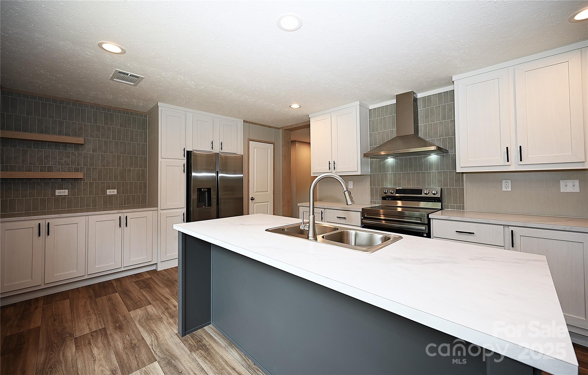 1157 Renno Road Clinton, SC 29325 - Photo 4 of 24 a kitchen with kitchen island a sink appliances and cabinets