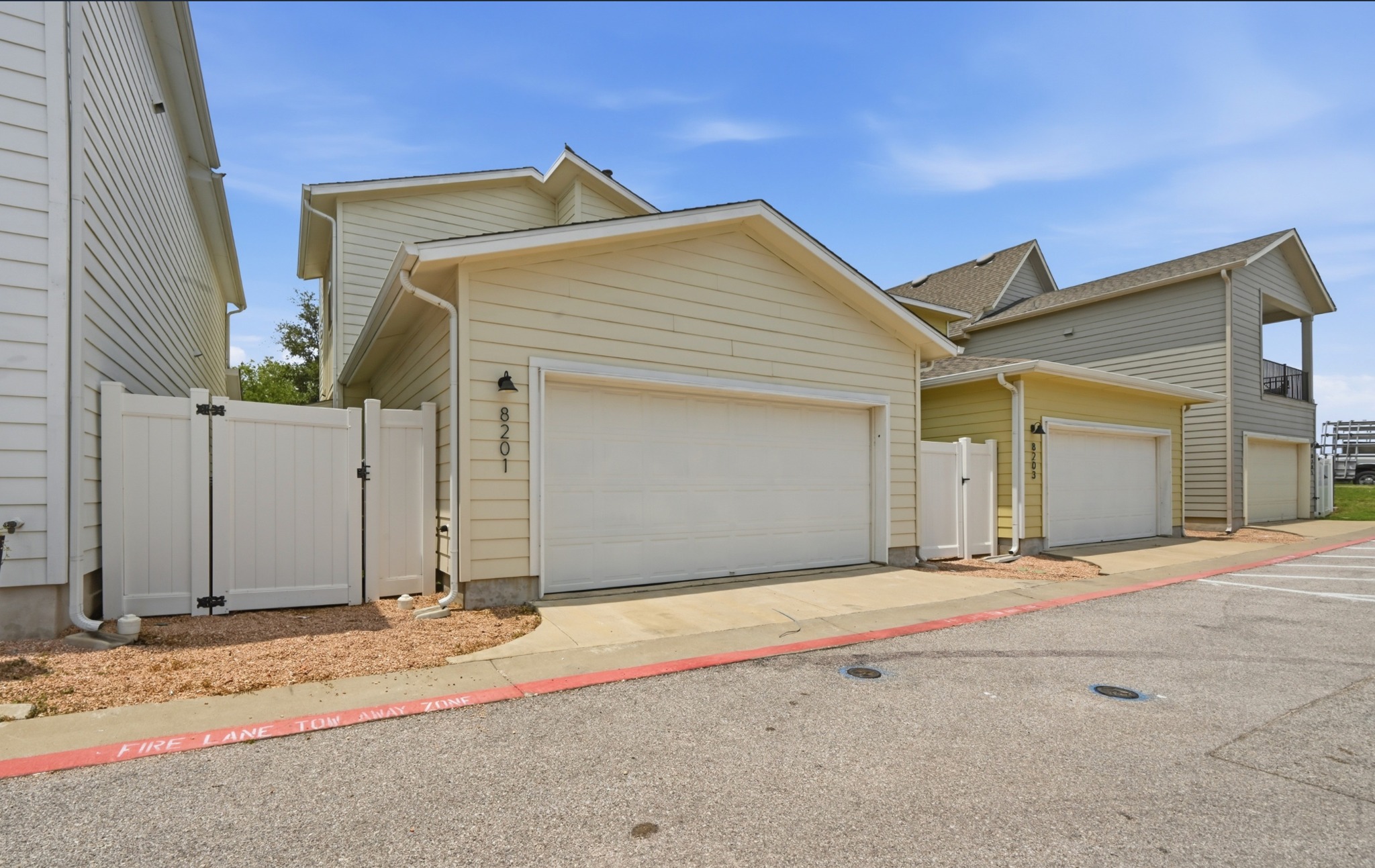8201 Frida Bend Austin, TX 78744 - Photo 27 of 29 Attached garage with private entry gates enhance this property's convenient and secure appeal.